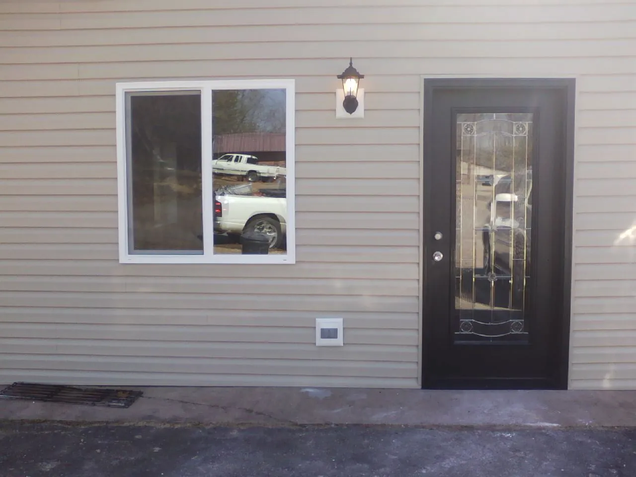 New siding, window and entry door on the side of an addition in Estill Springs
